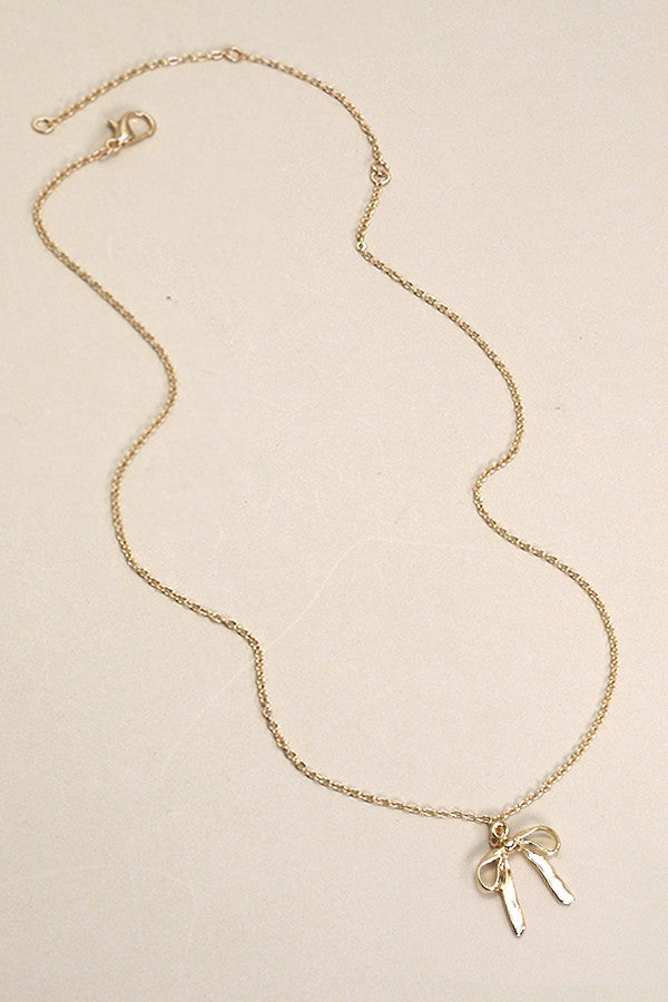 THE BOW PENDANT NECKLACE IN GOLD