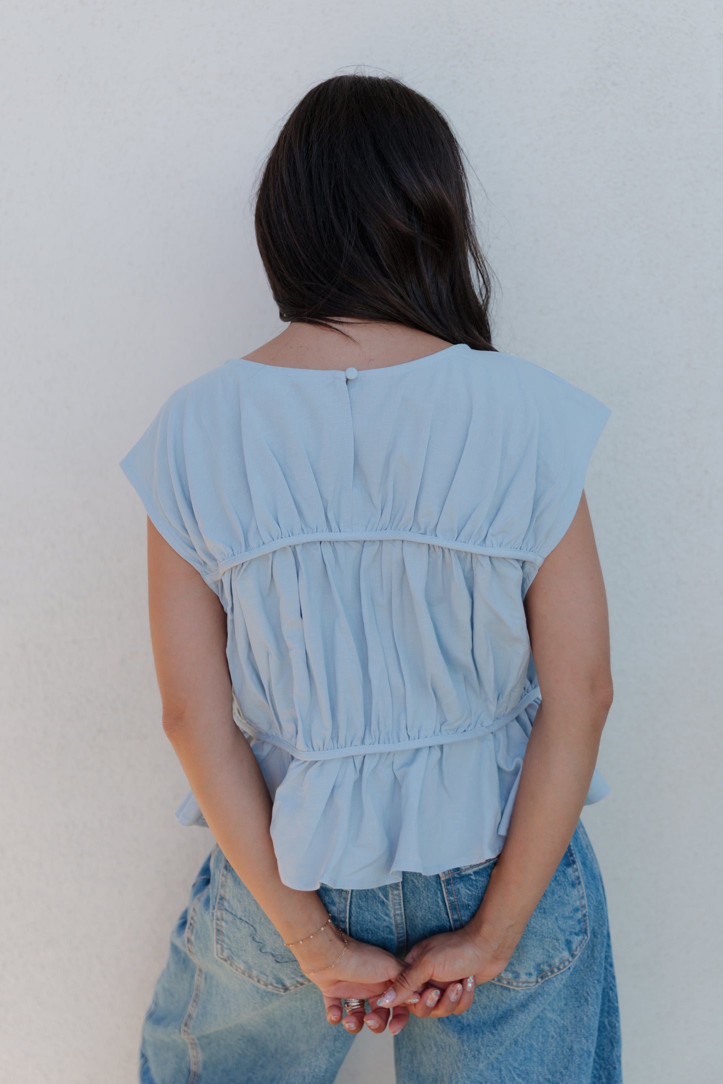 THE ANDREA RUCHED PEPLUM TOP IN SKY BLUE