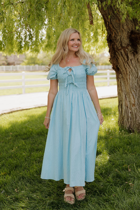 THE SUZANNAH BOW DETAIL DRESS IN BLUE