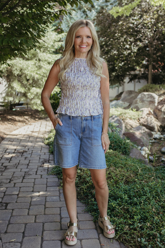 THE RENATA FLORAL SLEEVELESS SMOCKED BLOUSE IN LAVENDER