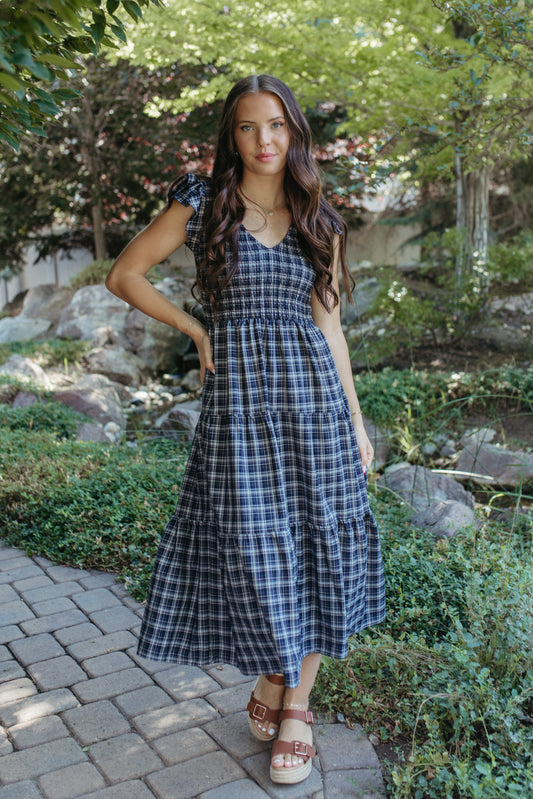 THE LEILANI PLAID TIERED SMOCKED DRESS IN NAVY