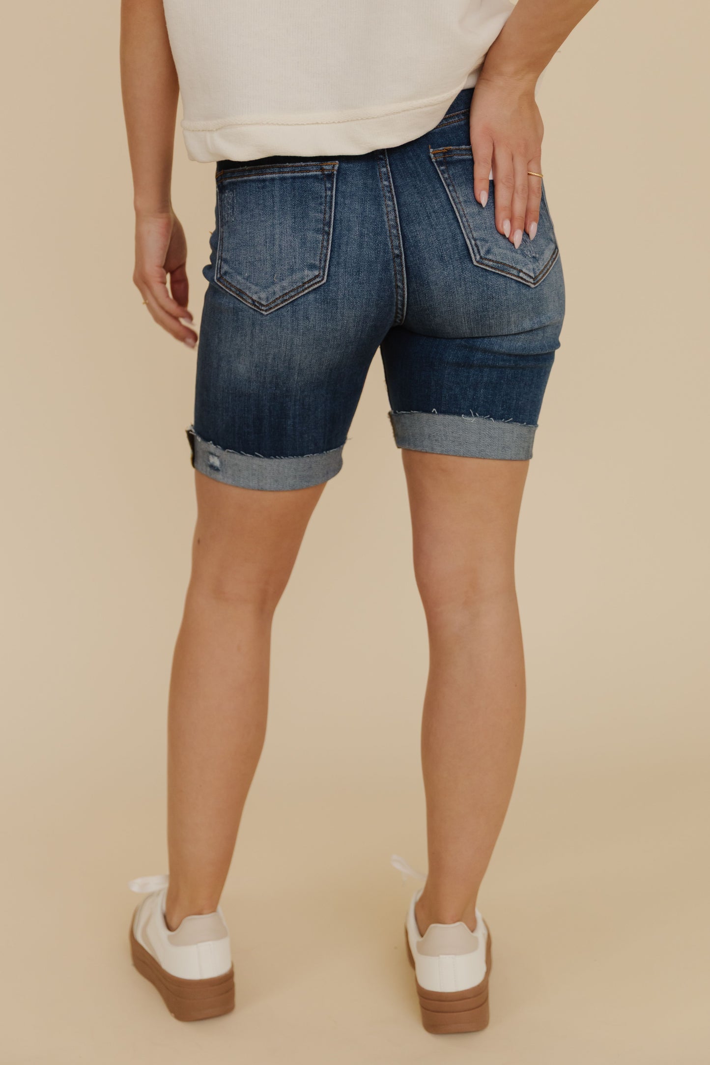 THE SCOUT HIGH RISE DISTRESSED SHORTS IN DARK DENIM