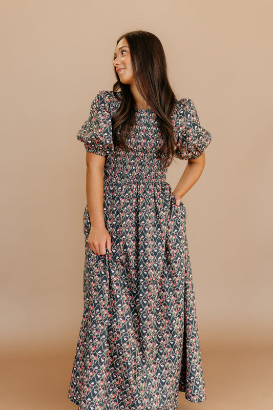 THE MAXINE SMOCKED FLORAL MAXI IN BLACK