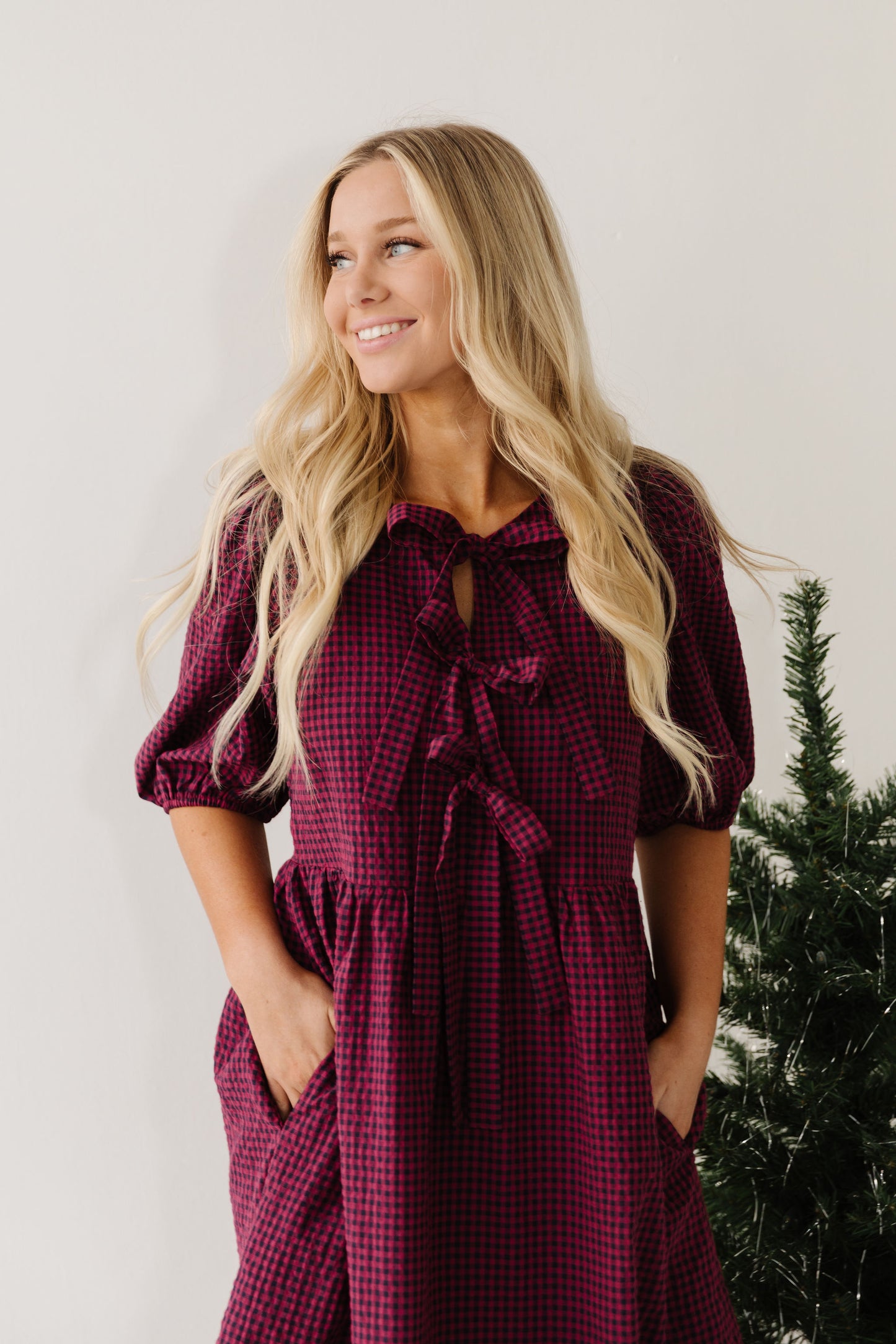 THE HARLOW BOW DRESS IN BURGUNDY CHECKERED BY PINK DESERT