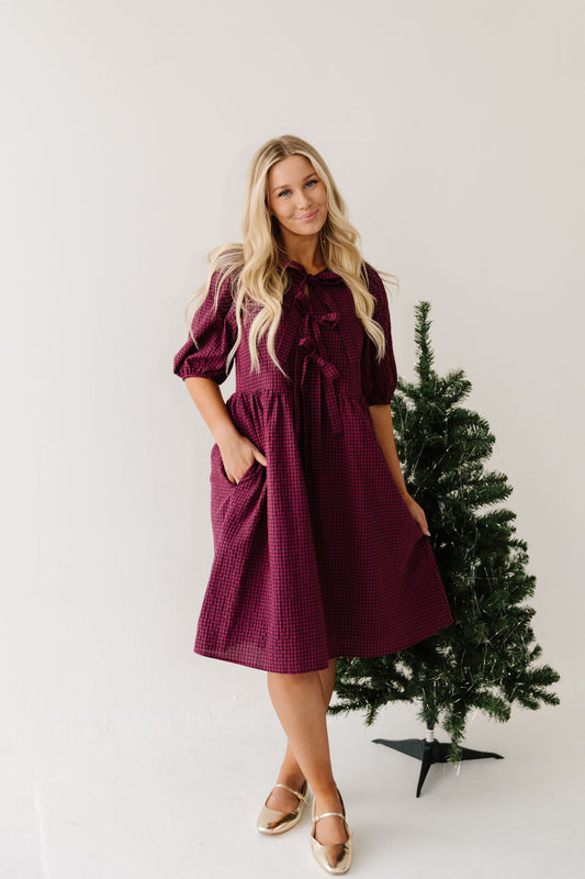THE HARLOW BOW DRESS IN BURGUNDY CHECKERED BY PINK DESERT