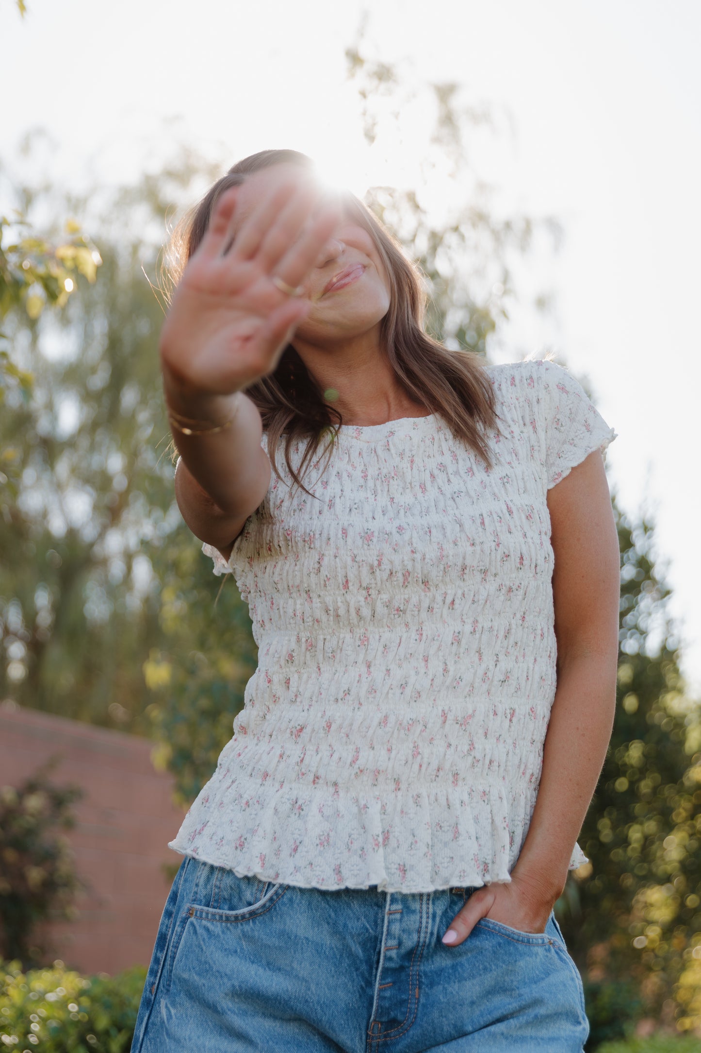 THE MADISON SMOCKED FLORAL TOP IN CREAM
