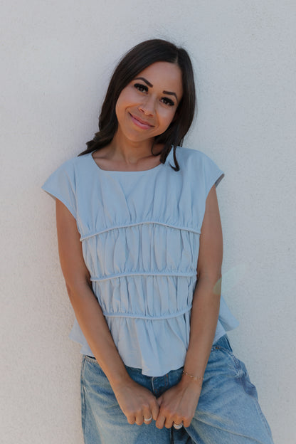 THE ANDREA RUCHED PEPLUM TOP IN SKY BLUE