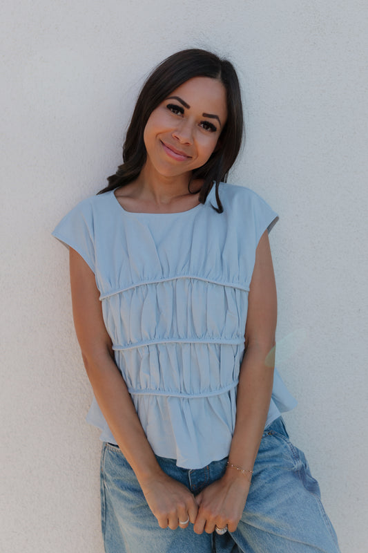 THE ANDREA RUCHED PEPLUM TOP IN SKY BLUE