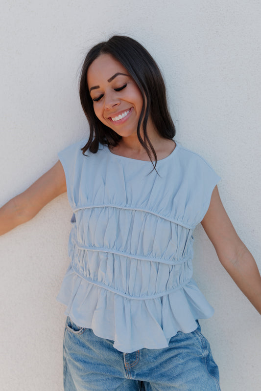 THE ANDREA RUCHED PEPLUM TOP IN SKY BLUE