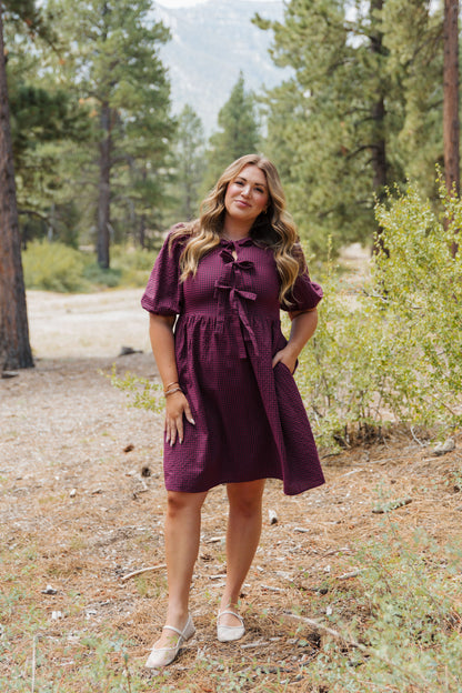 THE HARLOW BOW DRESS IN BURGUNDY CHECKERED BY PINK DESERT