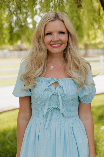 THE SUZANNAH BOW DETAIL DRESS IN BLUE