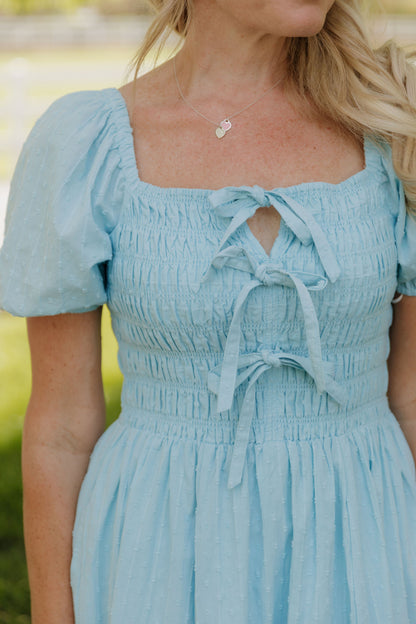 THE SUZANNAH BOW DETAIL DRESS IN BLUE