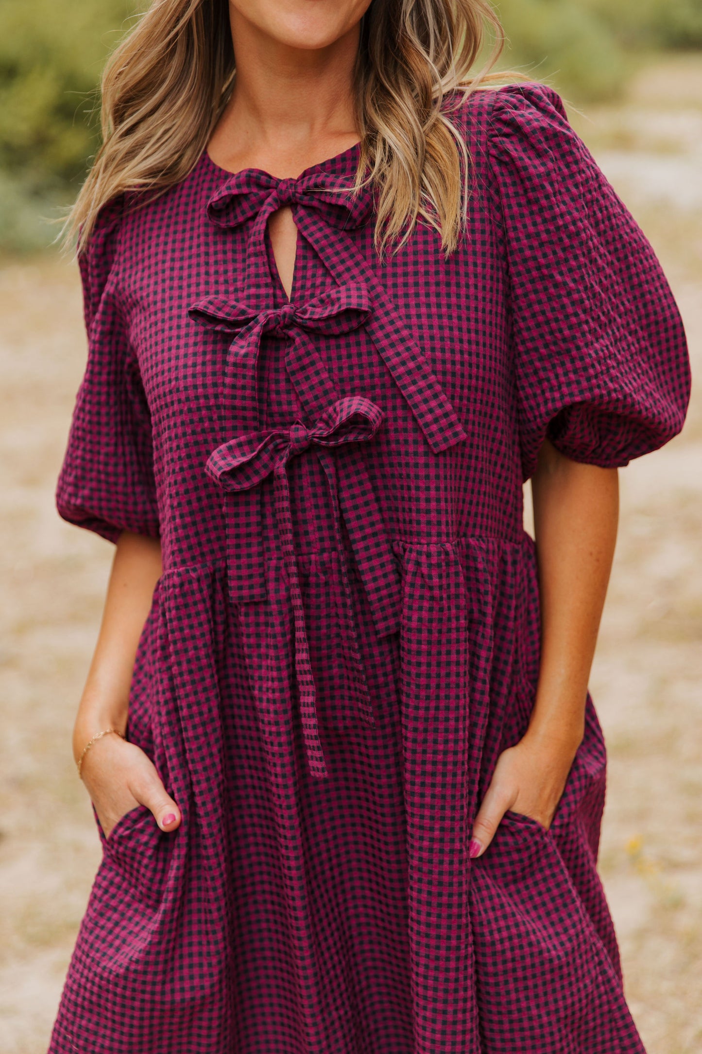 THE HARLOW BOW DRESS IN BURGUNDY CHECKERED BY PINK DESERT