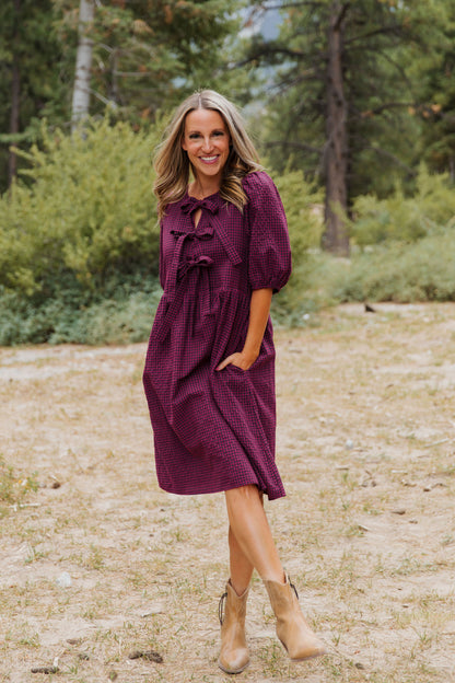 THE HARLOW BOW DRESS IN BURGUNDY CHECKERED BY PINK DESERT