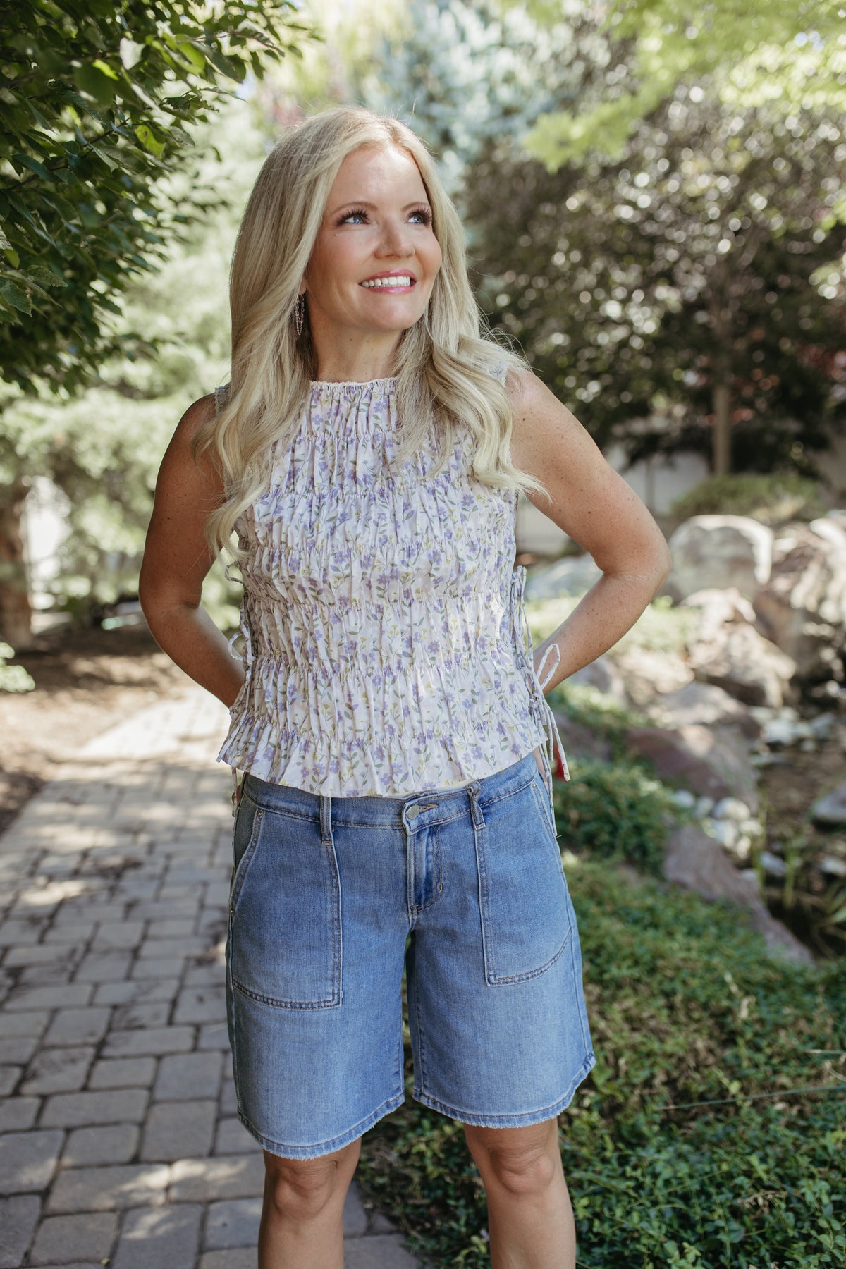 The Renata Floral Sleeveless Smocked Blouse in Lavender, photo 1 of 7