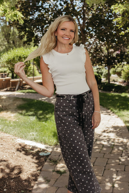 THE DAVINA SLEEVELESS RUFFLE KNIT SWEATER IN WHITE