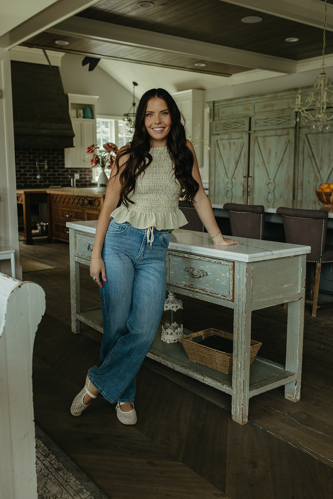 THE STORY SMOCKED PEPLUM TOP IN GREEN