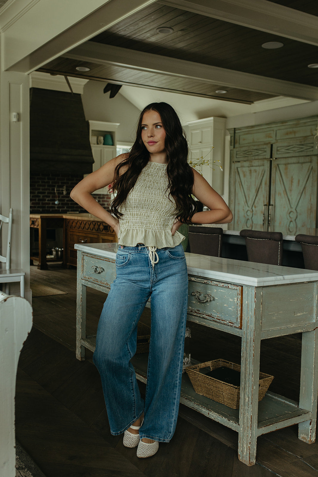 THE STORY SMOCKED PEPLUM TOP IN GREEN