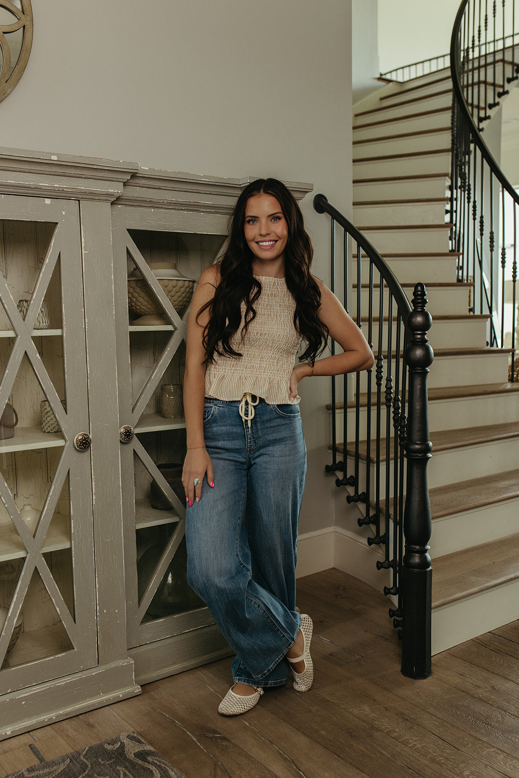 THE STORY SMOCKED PEPLUM TOP IN TAUPE