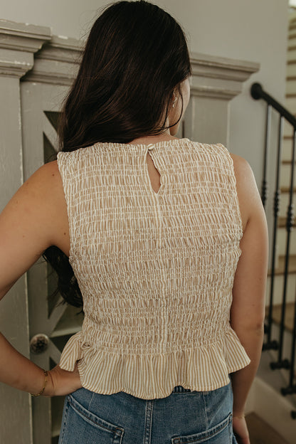 THE STORY SMOCKED PEPLUM TOP IN TAUPE