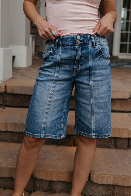 THE OLIVE SLOUCHY BERMUDA SHORTS IN MEDIUM WASH