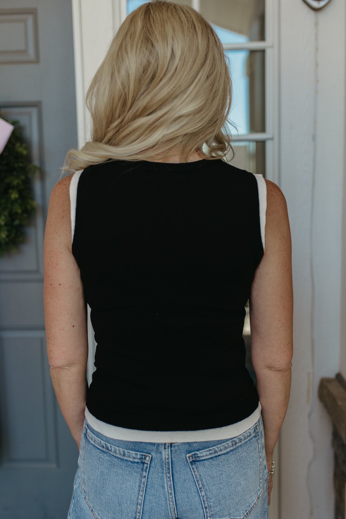 THE GRACELYNN SLEEVELESS SWEATER IN BLACK