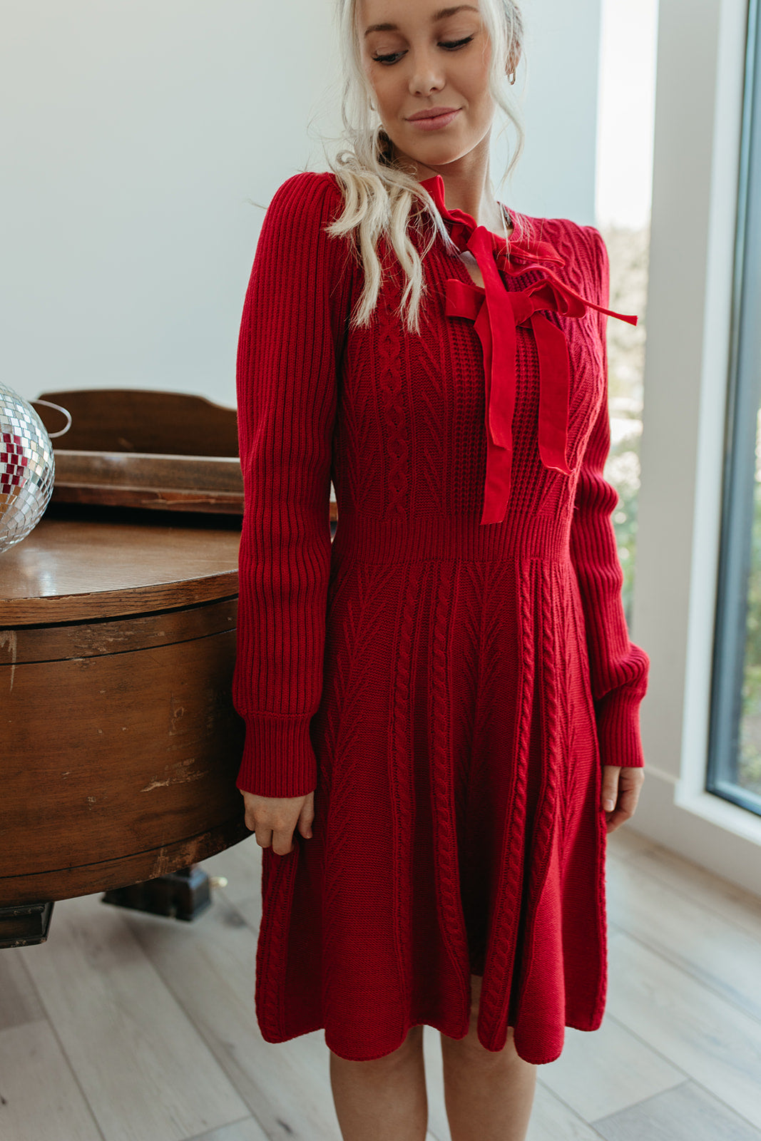 long sleeve red sweater dress Knit Mini with Pleated Skirt for Fall 15% Polyester Unlined Hand Wash Cold Manufactured in China Designed in The USA Model is 58 and Wearing a Size Small Rihoas Pleated Sweater Dress Lantern