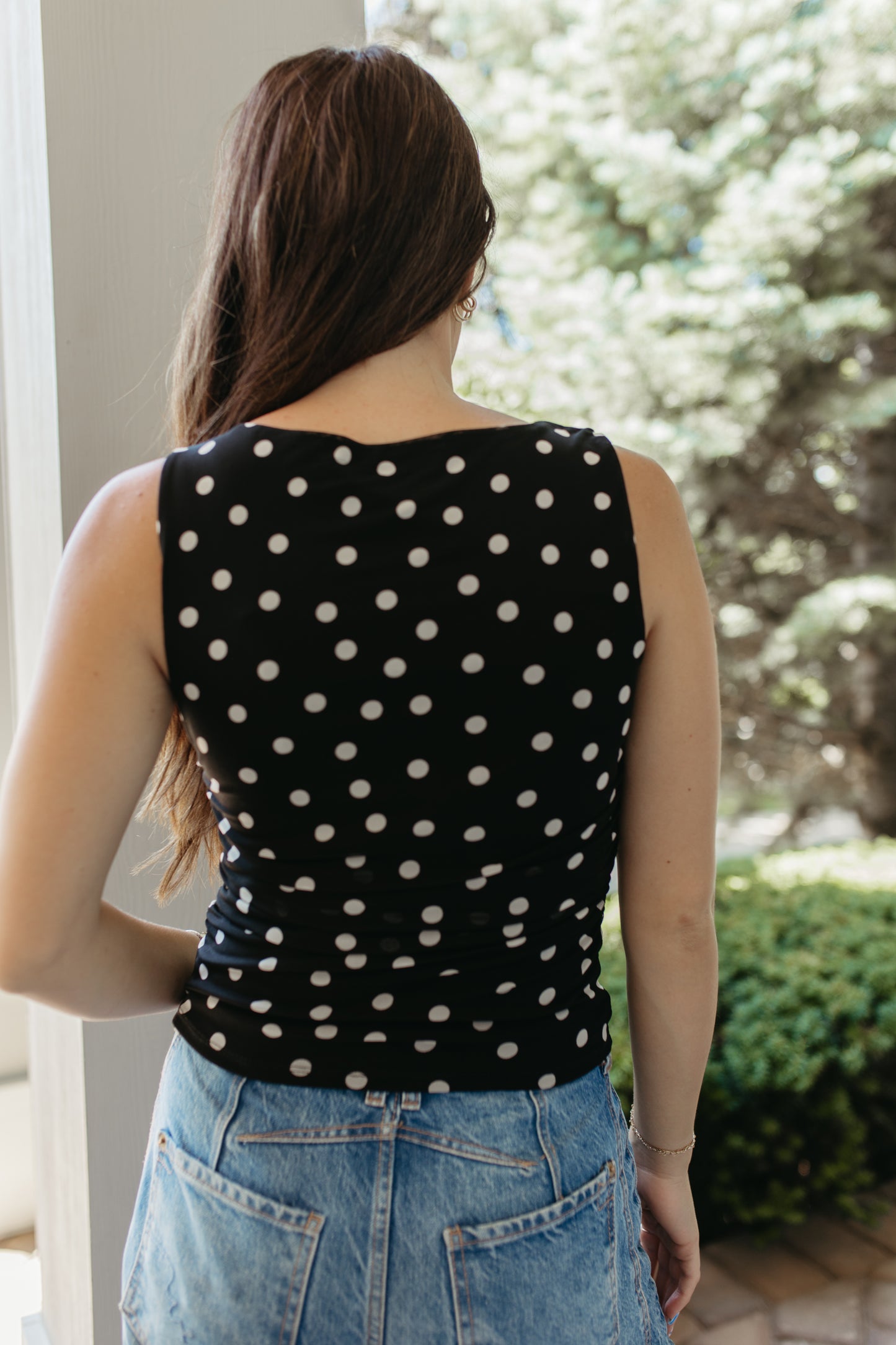 THE AINARA POLKA DOT SLEEVELESS KNIT TOP IN BLACK