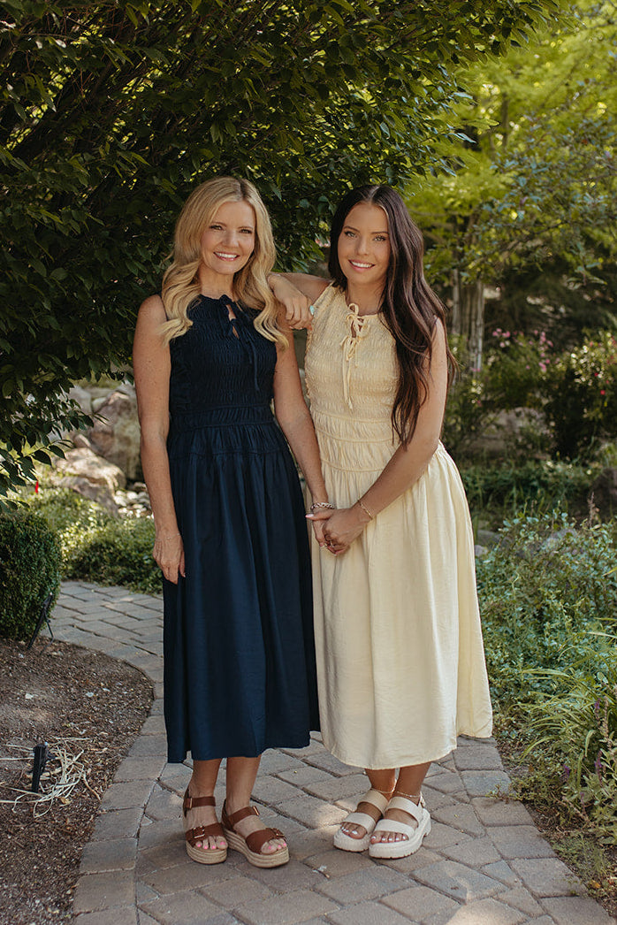 THE ROBIN FRONT TIE SMOCKED DRESS IN NAVY