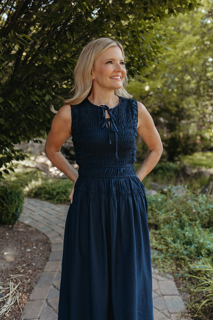 THE ROBIN FRONT TIE SMOCKED DRESS IN NAVY