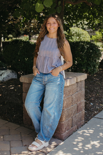 THE EVIE SKY MEADOW PEPLUM TOP IN NAVY