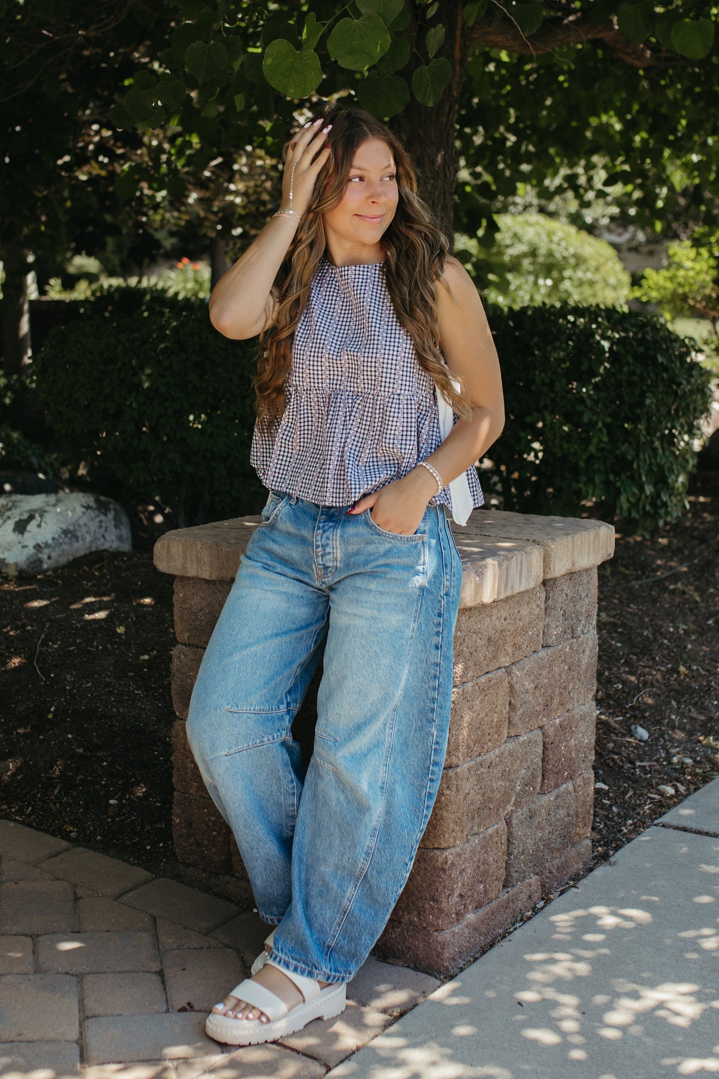 THE EVIE SKY MEADOW PEPLUM TOP IN NAVY