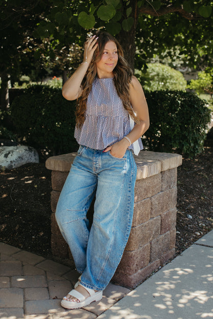 THE EVIE SKY MEADOW PEPLUM TOP IN NAVY