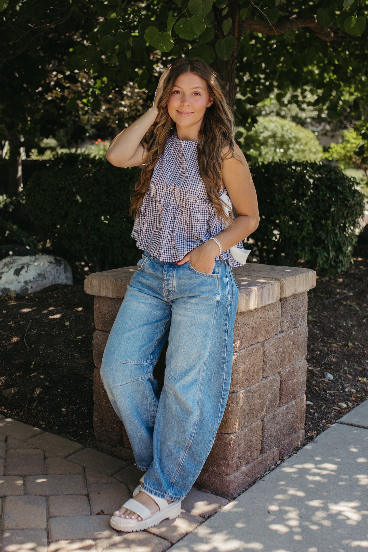 THE EVIE SKY MEADOW PEPLUM TOP IN NAVY