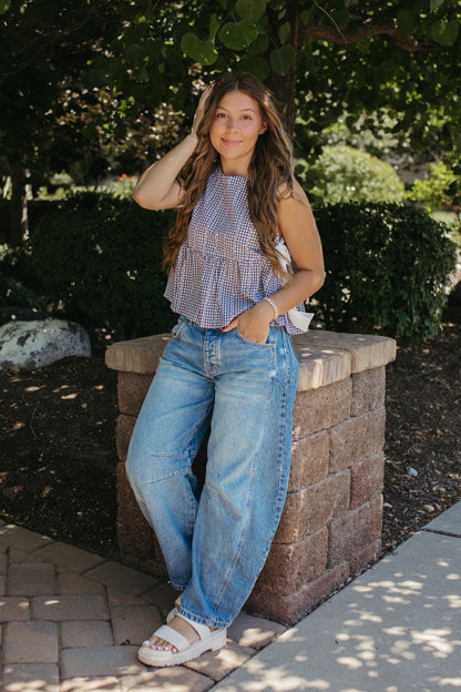 THE EVIE SKY MEADOW PEPLUM TOP IN NAVY