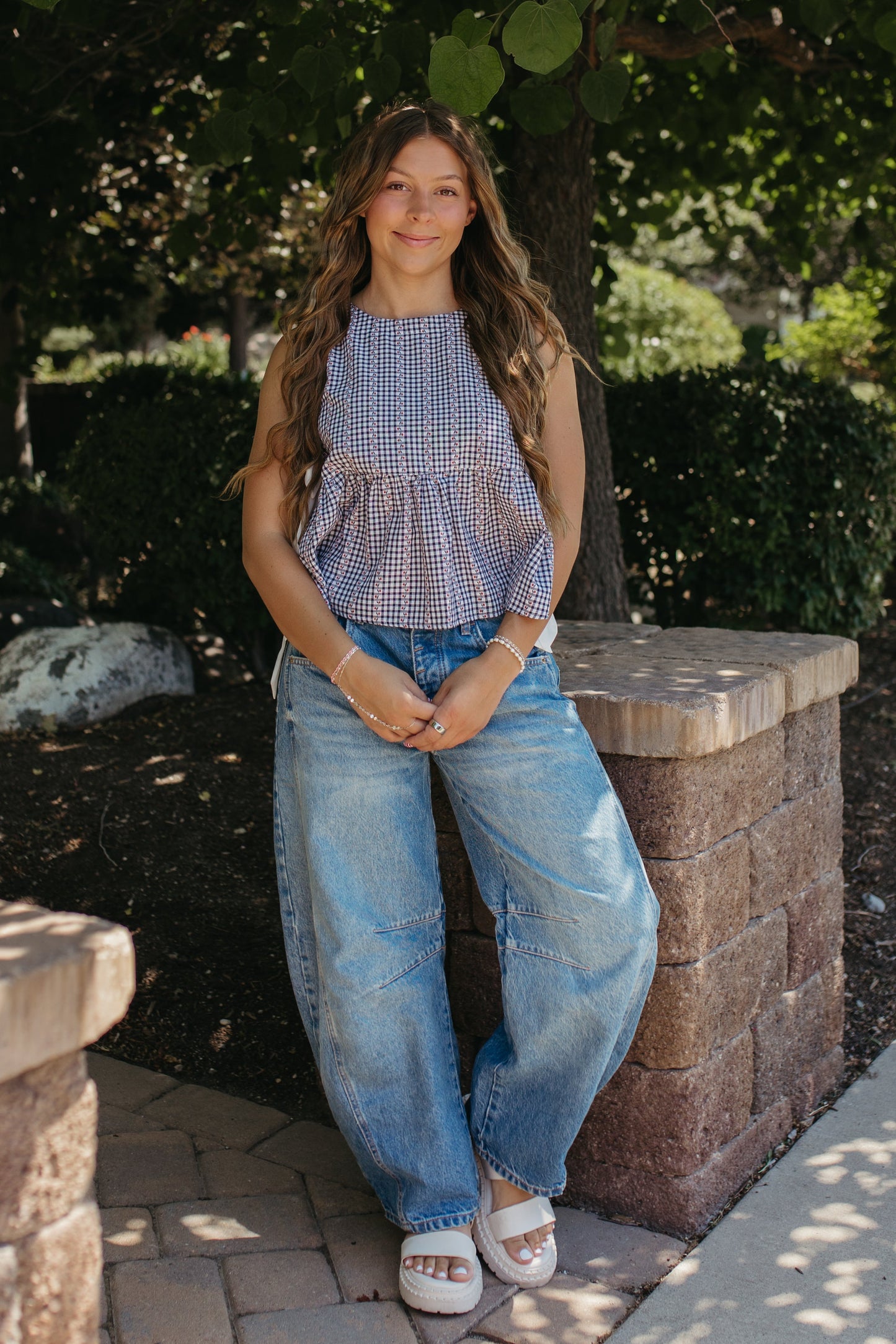 THE EVIE SKY MEADOW PEPLUM TOP IN NAVY