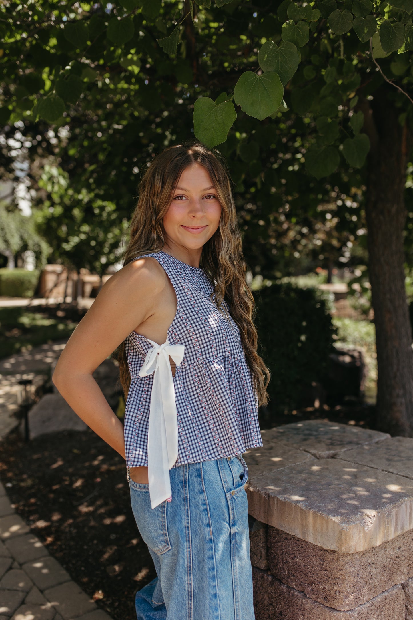 THE EVIE SKY MEADOW PEPLUM TOP IN NAVY