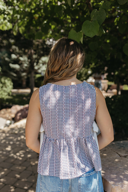 THE EVIE SKY MEADOW PEPLUM TOP IN NAVY