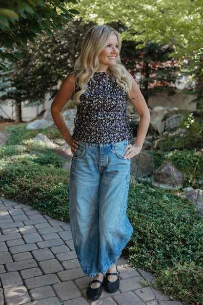 THE HAYDEN FLORAL SLEEVELESS SMOCKED BLOUSE IN BLACK