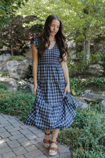 THE LEILANI PLAID TIERED SMOCKED DRESS IN NAVY