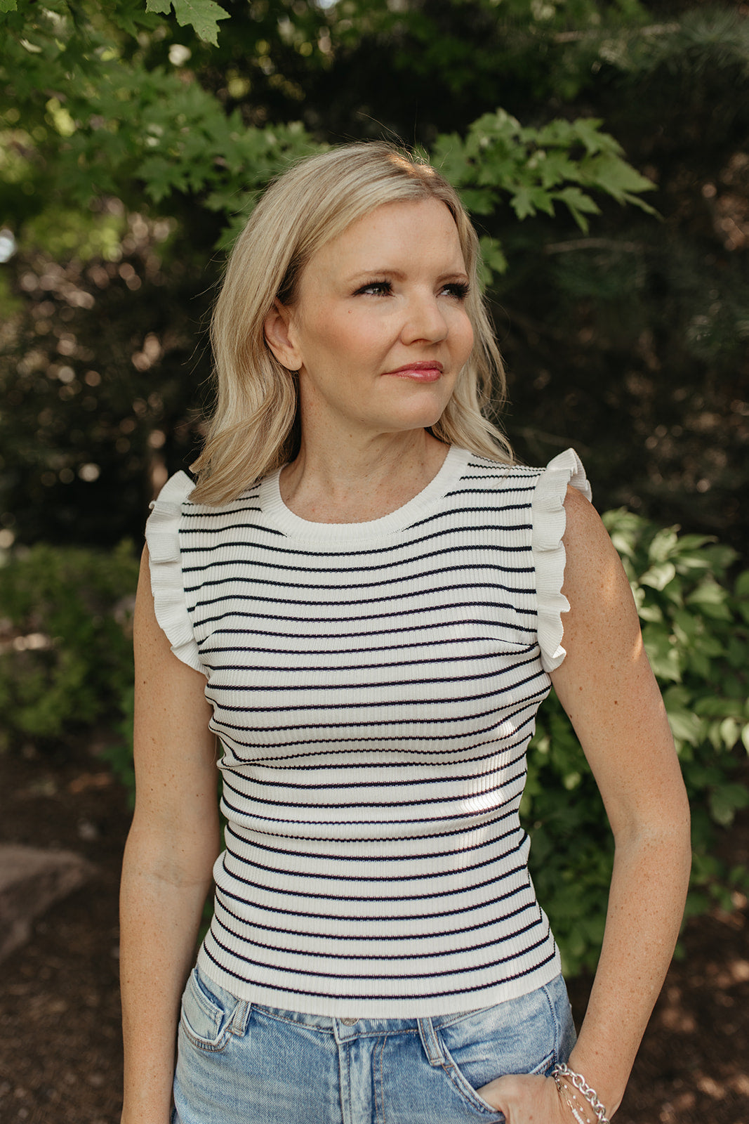 THE KARINA STRIPE SLEEVELESS RUFFLE SWEATER IN IVORY