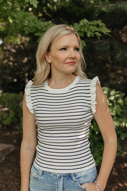 THE KARINA STRIPE SLEEVELESS RUFFLE SWEATER IN IVORY