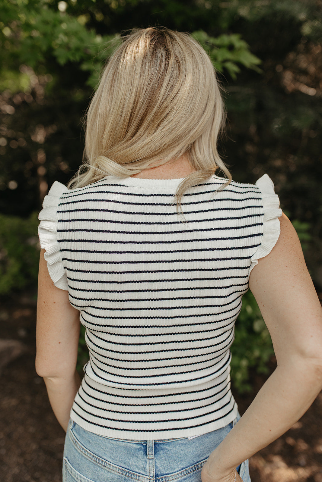 THE KARINA STRIPE SLEEVELESS RUFFLE SWEATER IN IVORY