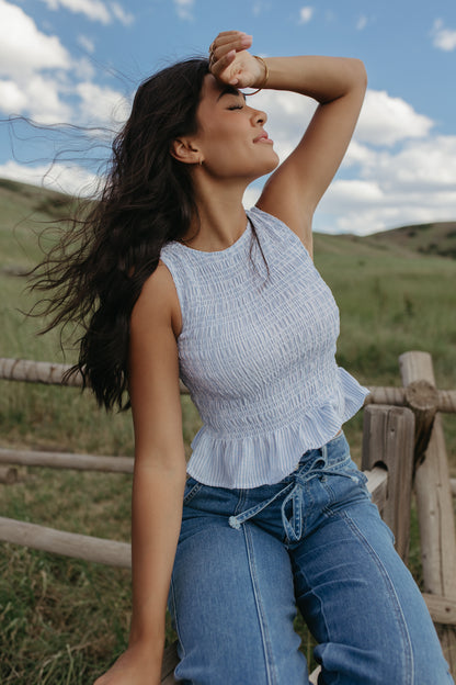 THE STORY SMOCKED PEPLUM TOP IN BLUE