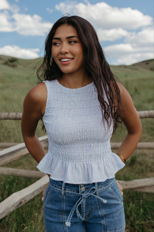 THE STORY SMOCKED PEPLUM TOP IN BLUE