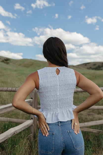 THE STORY SMOCKED PEPLUM TOP IN BLUE