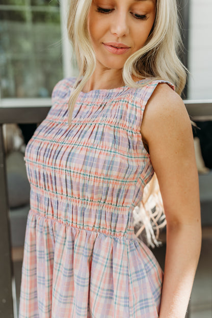 THE SAVANNAH SMOCKED PLAID DRESS IN CORAL