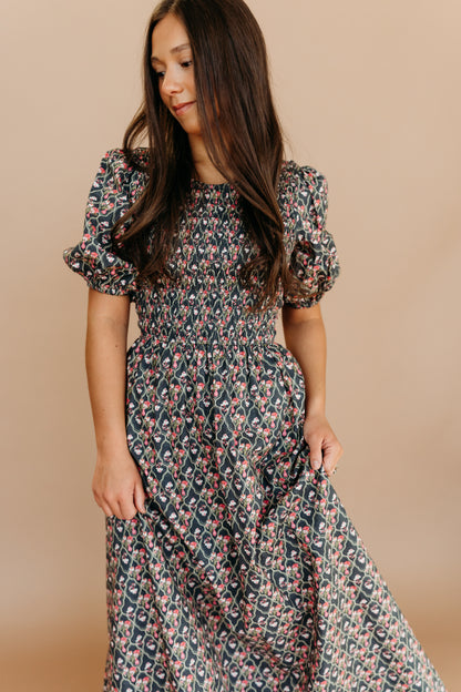 THE MAXINE SMOCKED FLORAL MAXI IN BLACK