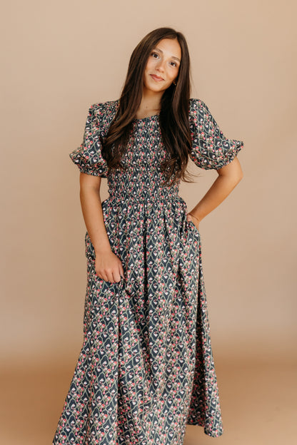 THE MAXINE SMOCKED FLORAL MAXI IN BLACK