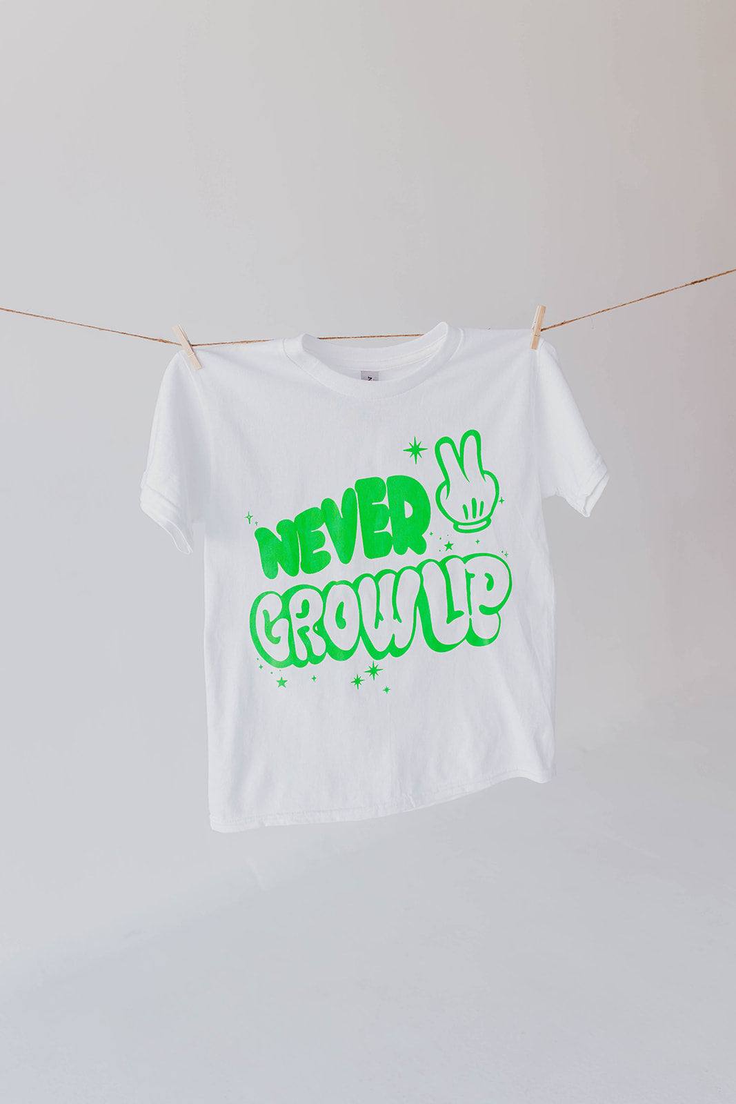 THE NEVER GROW UP KIDS TEE BY HAPPY THREADS X PINK DESERT IN WHITE AND GREEN